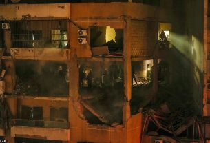 People search for survivors inside an apartment following a massive explosion in the southern suburb of Beirut, Lebanon
