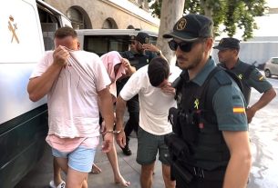 In exclusive footage obtained by MailOnline, four British men were seen being bundled out of a civil guard van and brought into the courthouse in Palma after they were involved in a violent beach brawl in Majorca on Wednesday