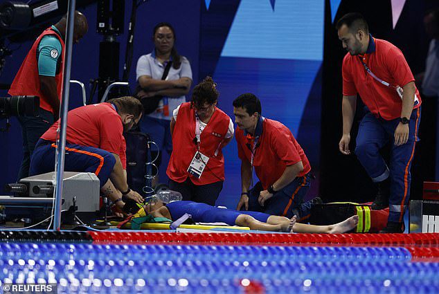 Tamara Potocka of Slovakia receives medical attention after her 200IM heat