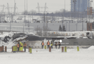 Investigators examine the wreckage of a Delta Air Lines plane a day after it crashed on landing at Toronto Pearson International Airport in Toronto, Ontario, February 18, 2025.