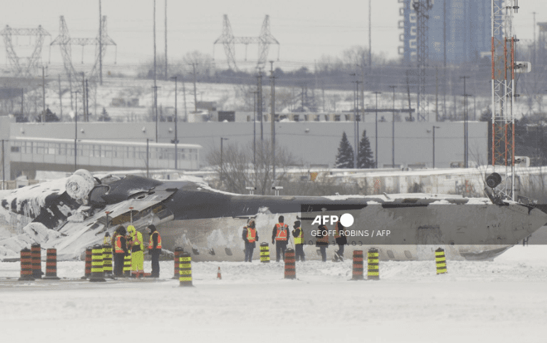 Investigators examine the wreckage of a Delta Air Lines plane a day after it crashed on landing at Toronto Pearson International Airport in Toronto, Ontario, February 18, 2025.