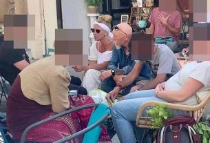 Fugitive mother Melanie Batty sitting next to her father David Batty (in denim shirt) and her son Alex Batty (in Black T-shirt) at the Esperaza market in June 2023