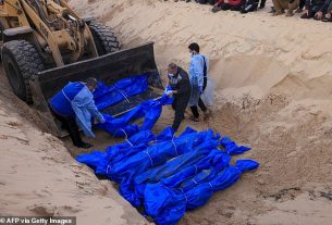 The shrouded bodies of Palestinians killed in nothern Gaza, that were taken and later released by Israel, are buried in a mass grave in Rafah, on the southern Gaza Strip on December 26, 2023