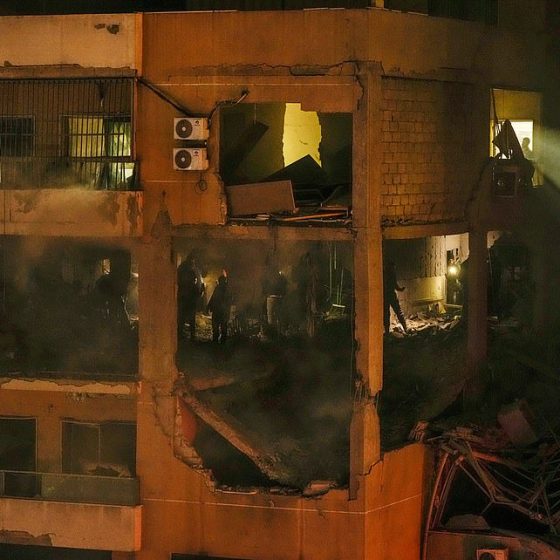 People search for survivors inside an apartment following a massive explosion in the southern suburb of Beirut, Lebanon