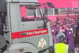 Vehicles emblazoned with Rosgvardiya (Rosguard, the National Police) were seen outside the warehouse in Moscow as officials rounded up illegal migrants, some destined for Ukraine