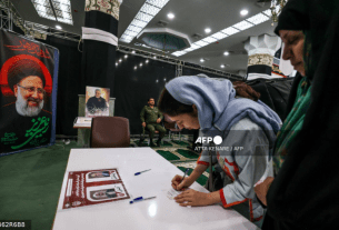 Iranian women prepare to cast their ballots at a polling station in Tehran on July 5, 2024.