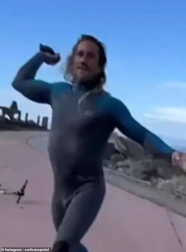 This is the shocking moment an enraged Tenerife surfer hurled rocks at tourists after accusing one of them of stealing his waves while out in the sea